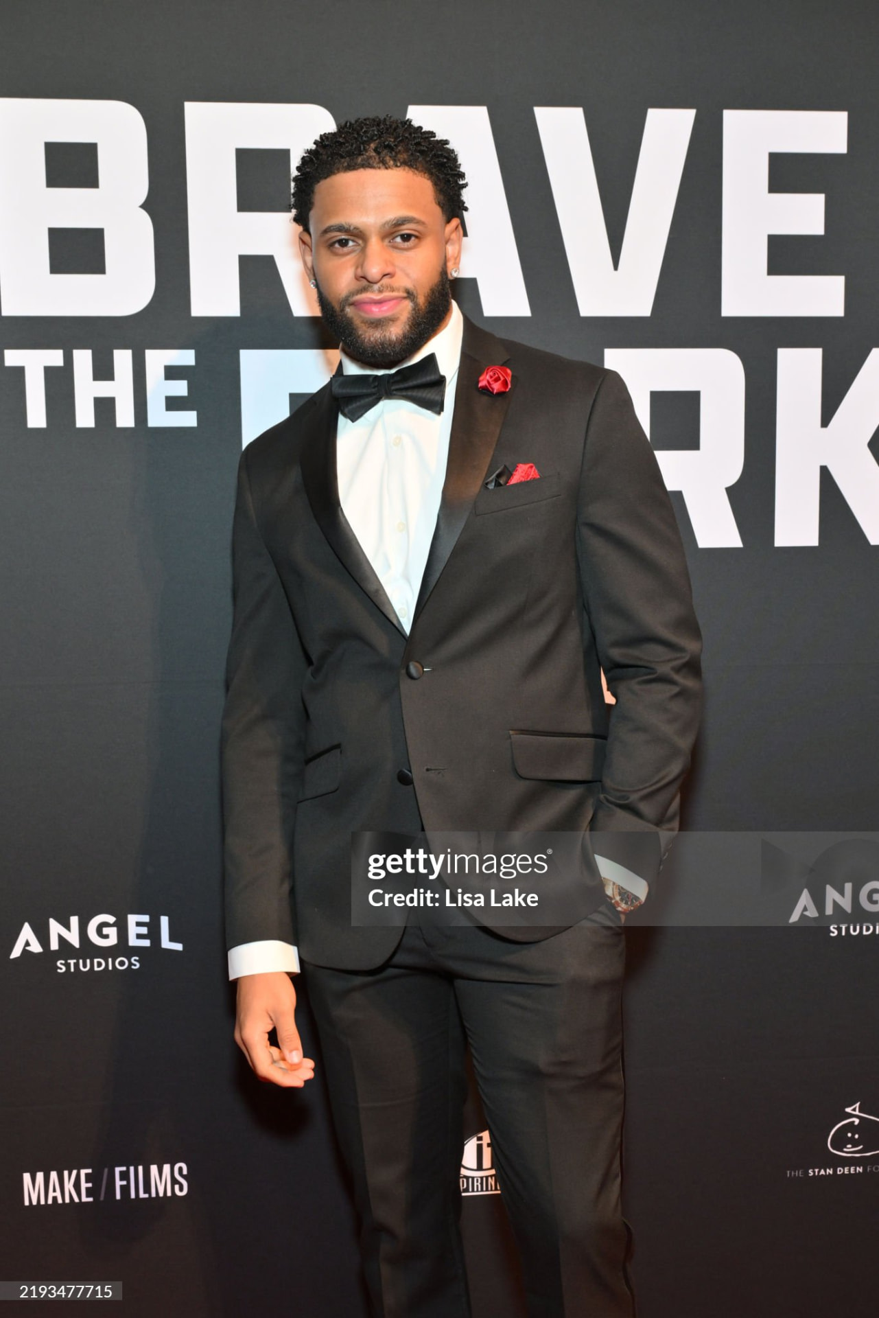 Brandon Miles in a black tuxedo at the Brave the Dark premiere, with the original Getty Images credit visible