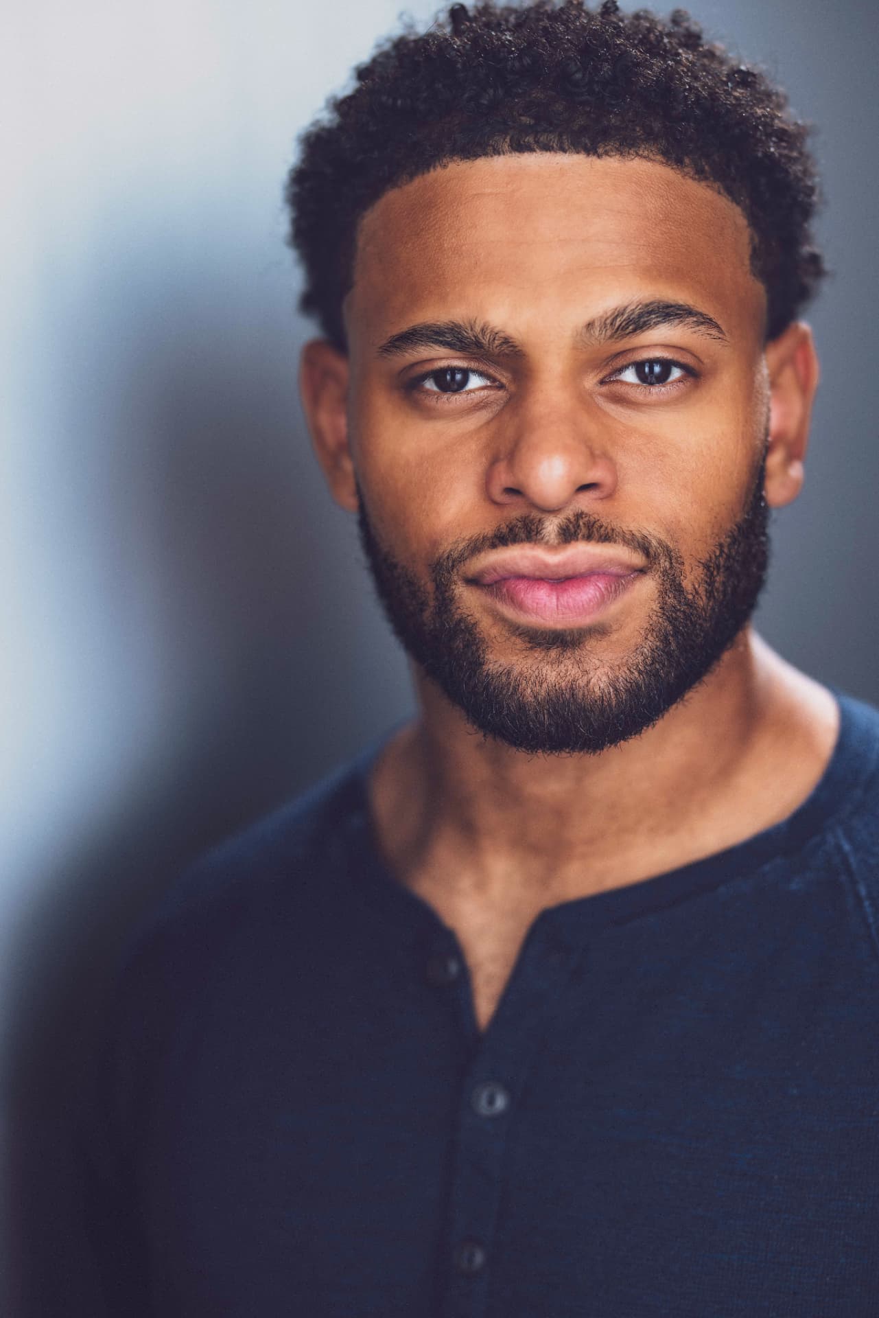 Portrait of Brandon Miles in a dark henley